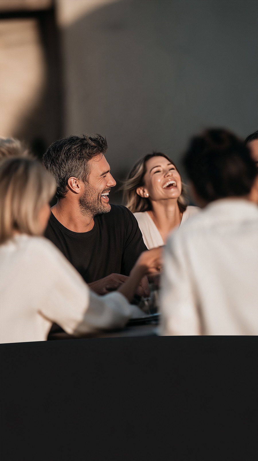Friends laughing together at a table